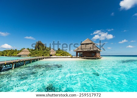 small tropical island with beach villas