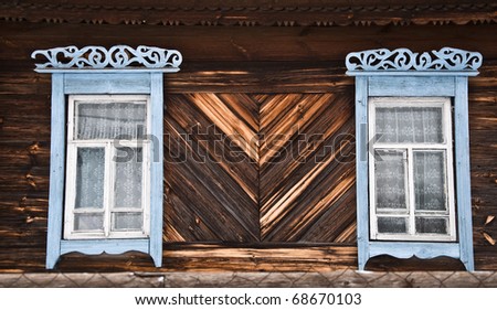 Old rustic wall with a window. Fragment, close-up. Rural life.