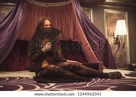 Glamor woman in transparent clothes on bed