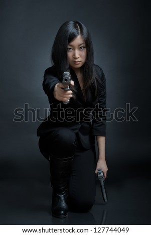 Asian woman with a pistol