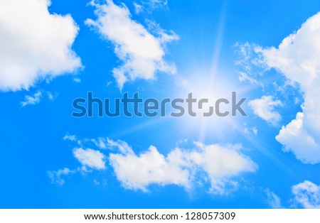 Bright sun in blue sky with clouds