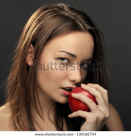 Beautiful woman posing with red apple