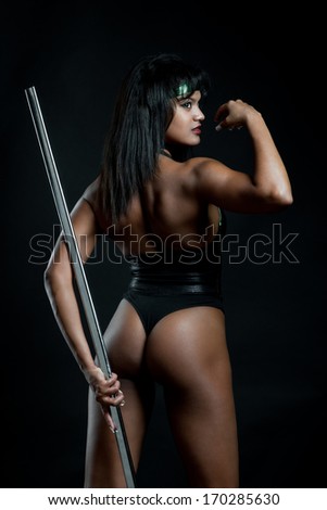 Fighter woman posing against black background