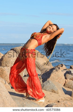 Woman in indian dress dancing with sabre