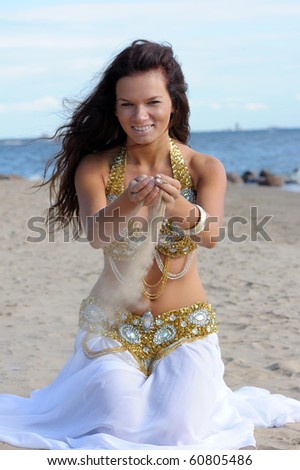 Beautiful woman play with sand