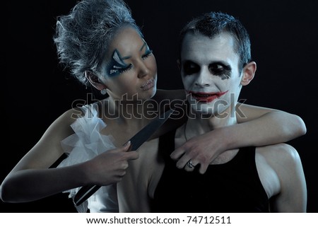 Spooky man and woman in darkness
