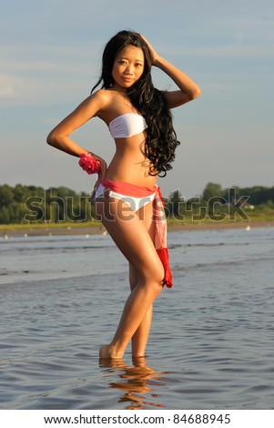 Beautiful asian woman in white bikini at sea