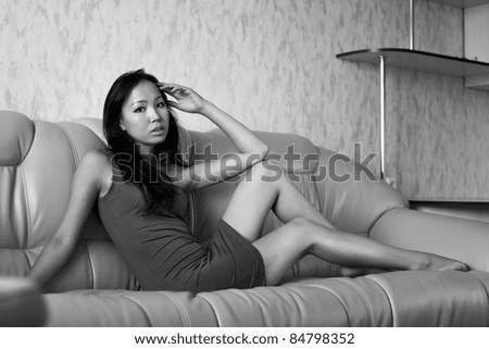 Sad asian woman sitting on the sofa
