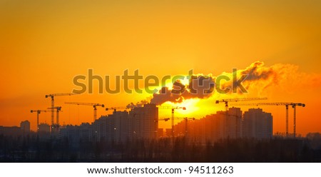 Construction site silhouetted at sunset