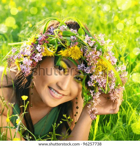 Asian woman in nature with flower wreath on head