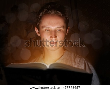Man reading book in the darkness