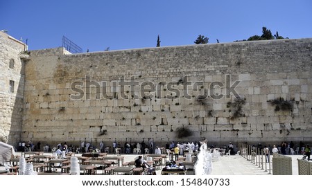 The wailing wall and praying people in old city of Jerusalem.