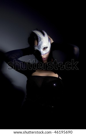 Dark portrait of a beautiful girl with white mask