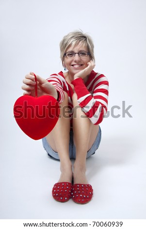 Young attractive woman with red heart on white background