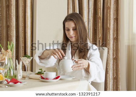 Woman having breakfast in hotel