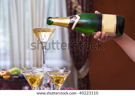 pouring of champagne to the glasses