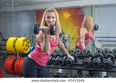 woman at the gym exercising with free weights
