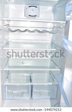 Open empty refrigerator with shelves