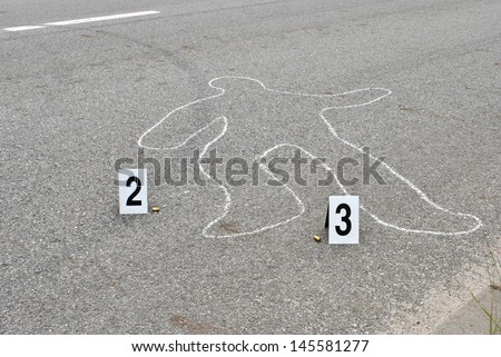 Chalk outline of human body on the street