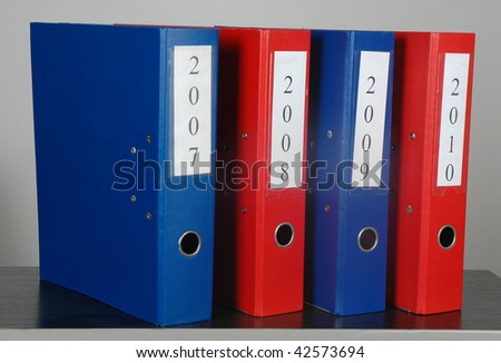 four ring binders two red and two blue