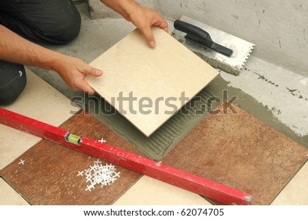 arranging  tiles on the floor