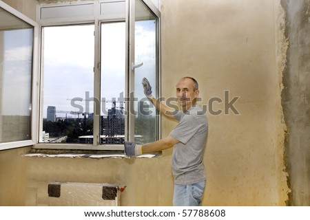 a man washing windows in a new apartment