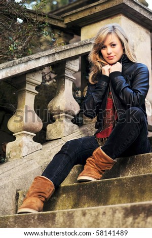 Outdoor Fashion Portrait Of Young Woman SItting On Steps