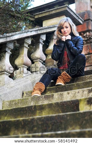 Retro Outdoor Portrait Of Young Woman On Steps