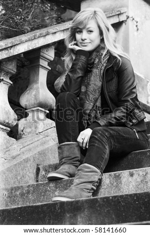 Outdoor Fashion Portrait Of Young Woman Sitting On Steps