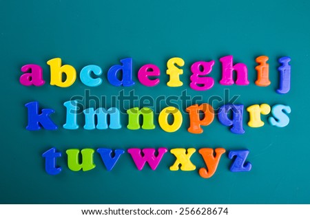 Colorful Alphabet magnetic letters on green background