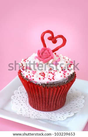Chocolate cupcake with vanilla icing decorated with love