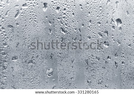 Muddy misted window glass with water drops as background