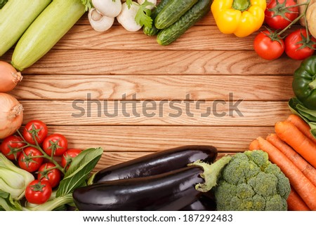 Vegetables on wood background with space for text. Organic food.