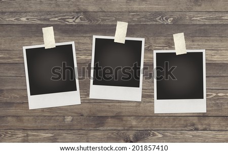 Photo frame on wooden background for design or montage