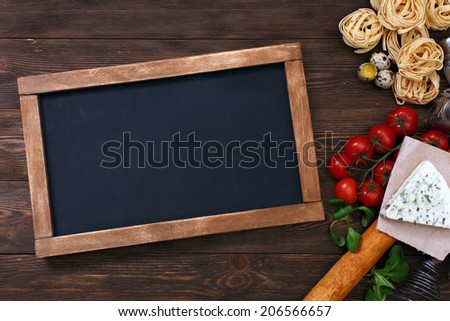 Italian food on vintage wood background with chalkboard with copyspace Italian food on vintage wood background with chalkboard with copyspace