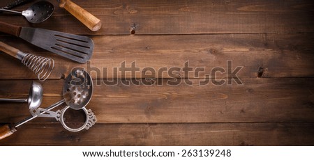 Vintage kitchen items on wooden background.