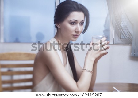 beautiful brunette woman with glass of whiskey