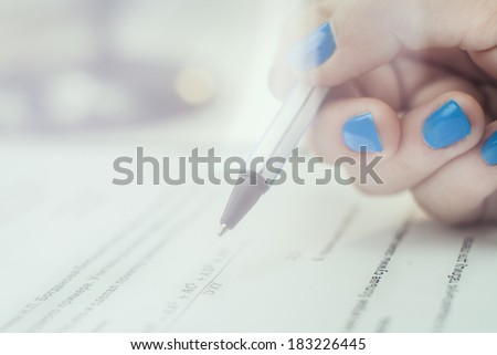 Hand with pen choosing the test list on the examination