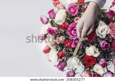 hand holding a basket of flowers