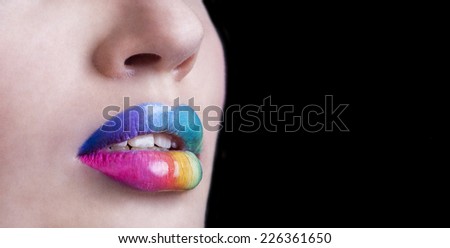 Sensual lips rainbow makeup. Beautiful bright make-up and vivid colors. Close up photography of sexy female mouth with funny summer visage