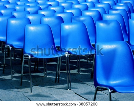 the blue seats of an outdoor cinema