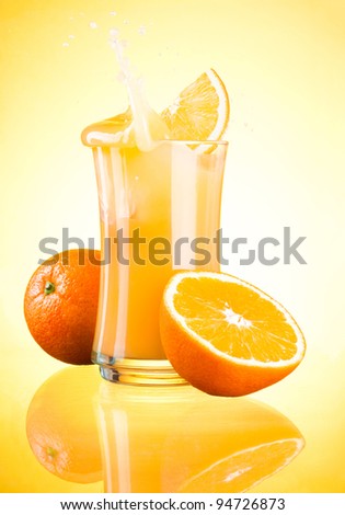Splashing Fresh Orange Juice on yellow background