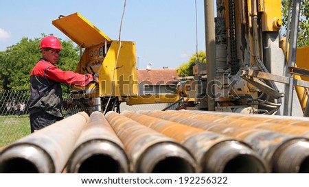 Drilling Rig Operator. Oil and gas industry. Oil and gas well drilling worker operate drilling rig machinery.