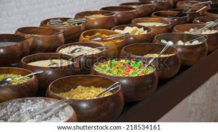Cereals and Corn Flakes on a Breakfast Buffet. Cereal bar. Breakfast buffet restaurant food in a hotel.