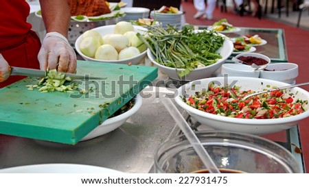 Chef Chopping Salad Ingredients. Making salad buffet.  Chef Chopping Vegetables. Chef Making Salad in a restaurant.