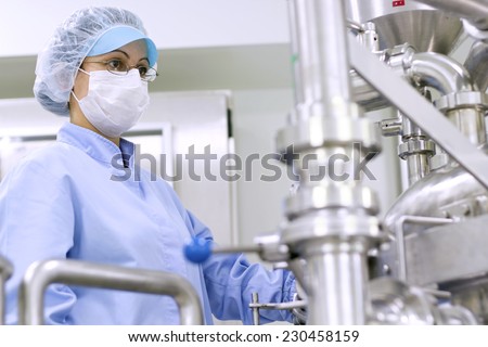 Pharmaceutical Manufacturing Technologist. Preparing machine for work in pharmaceutical factory.Chemical industry. Pharmaceutical Factory Worker. Pharmaceutical Industry. Technology background.