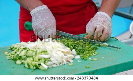Chef Chopping Vegetables. Chef at work in restaurant kitchen.\
Chef Chopping Salad Ingredients.Food preparation.