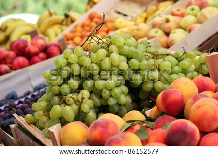 Fresh Fruit Stand . A fruit stand selling grapes, nectarines, apples, bananas, and other fresh fruit.