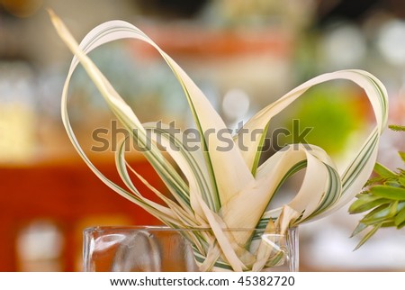 stock photo Protea leaves tied as ribbons as decorations on table