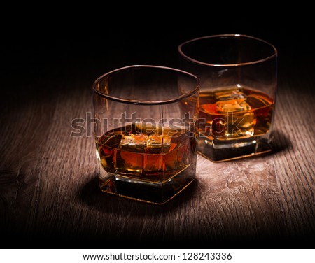 Whiskey In Glasses On Wooden Table